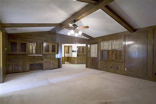 A Living Room With Painted Paneling And Wood Beams