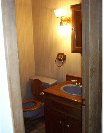 A Sage Green Bathroom With Orange Accents