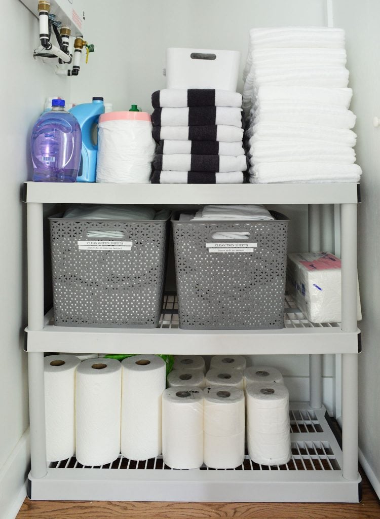 Duplex Owners Closet With Plastic Shelving Labeled Bins
