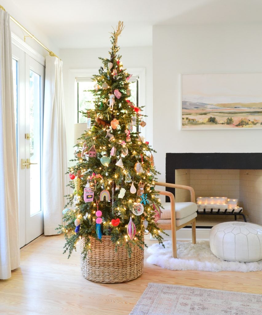 Woven Basket At Base Of Christmas Tree With Colorful Ornaments