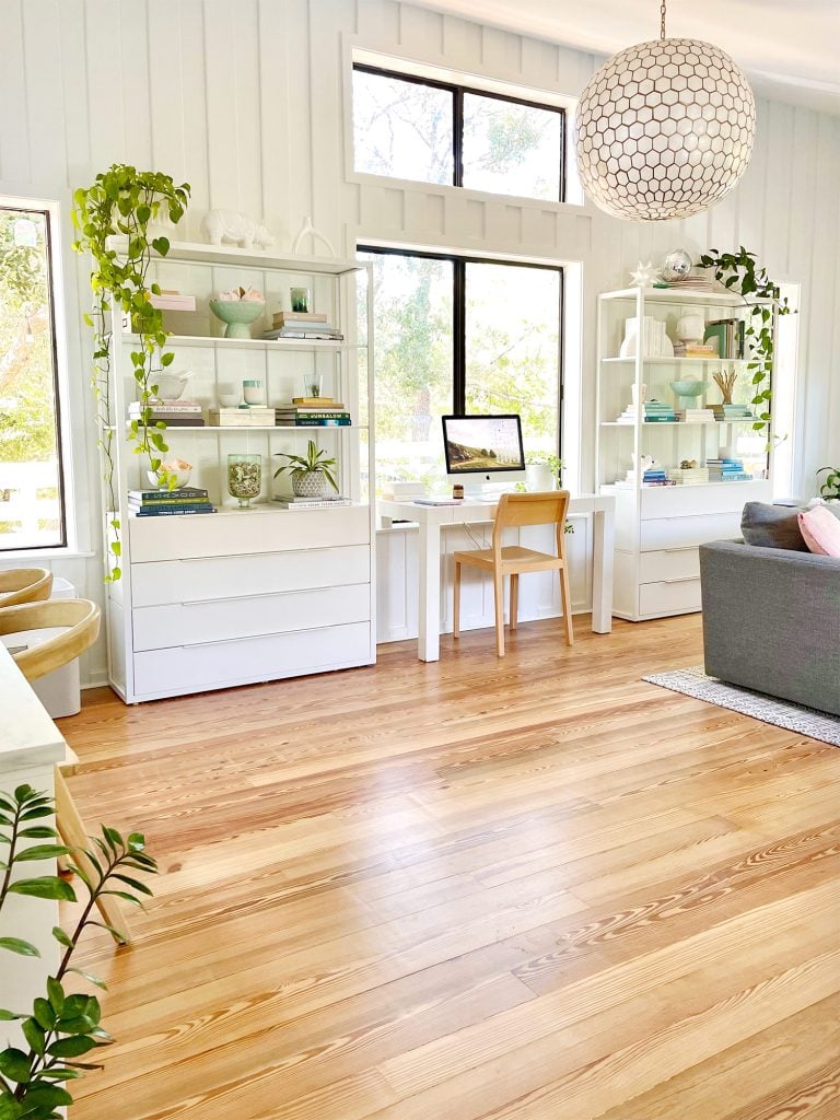 Two Ikea Fjalkinge Bookcases Flanking Office Deck In Middle Of Modern White Upstairs Family Room With Large Windows
