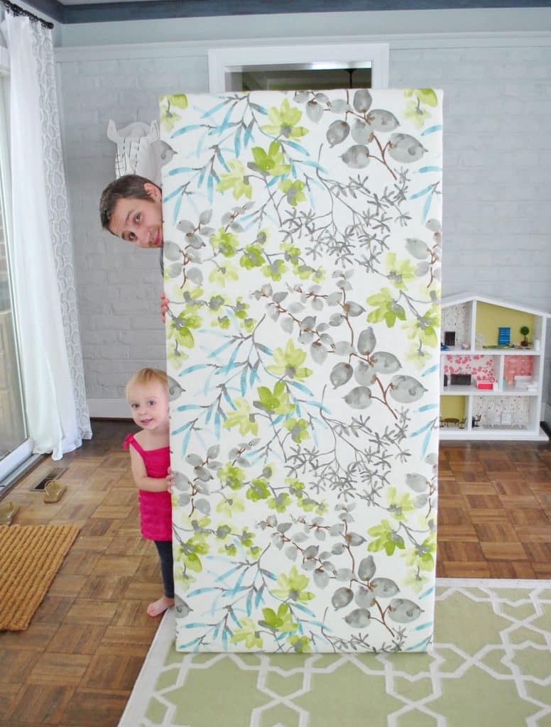 John standing with finished DIY fabric headboard