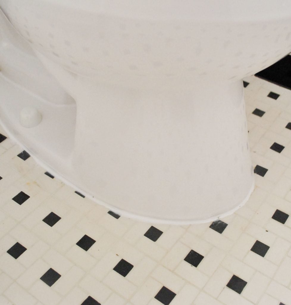 Line Of White Caulk Around Base Of Installed Toilet