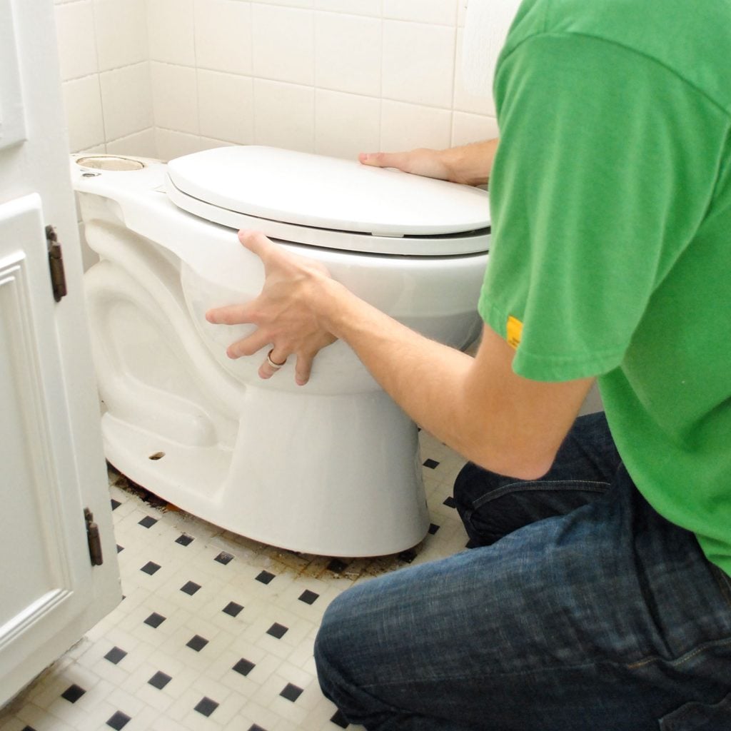 John Rocking Old Toilet Bowl To Loosen Wax Ring
