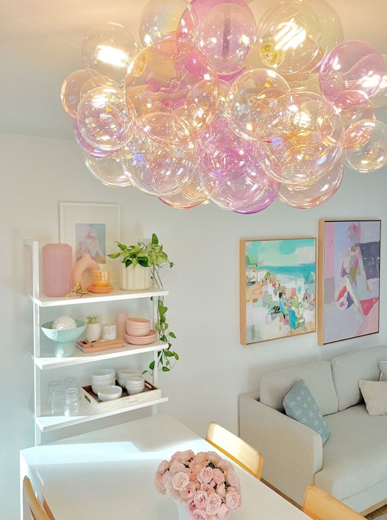 Glass Bubble Light Fixture In Purple And Pink Above Kitchen Table