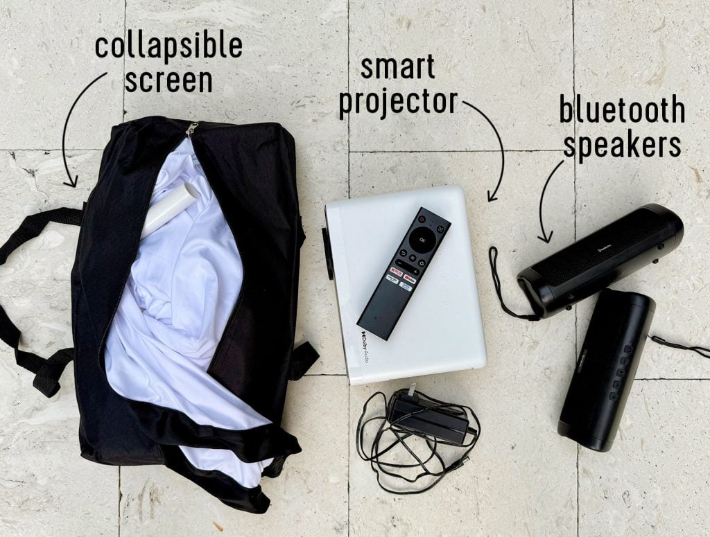 3 Items needed for an outdoor movie night collapsible screen smart projector and bluetooth speakers