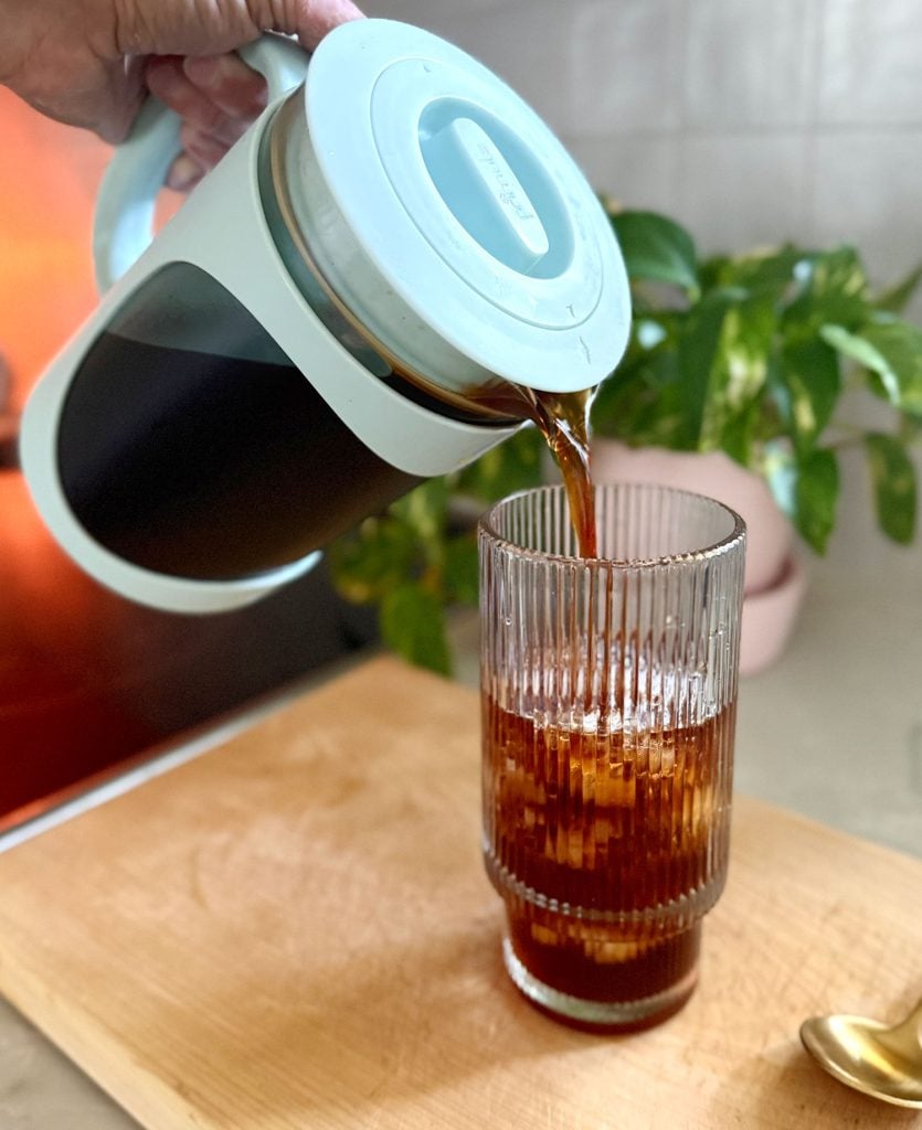 Pouring Homemade Cold Brew Into Glass With Ice