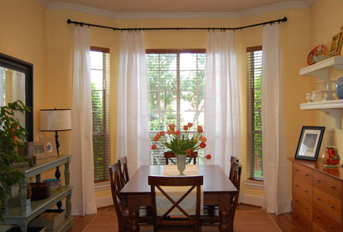 bay-window-curtains-before-and-after-how-to-hang curtains high and wide over your bay window