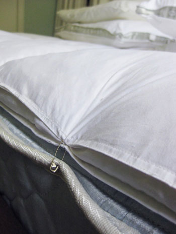 Using Safety Pins To Keep A Mattress Topper In Place