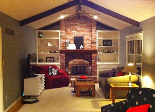 A Painted White Brick Fireplace In A Vaulted Living Room