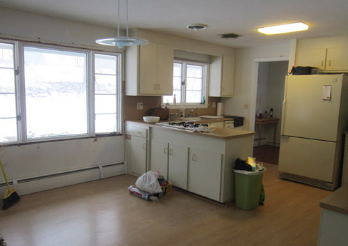 A Kitchen With Dark Gray Lower Cabinets & White Uppers