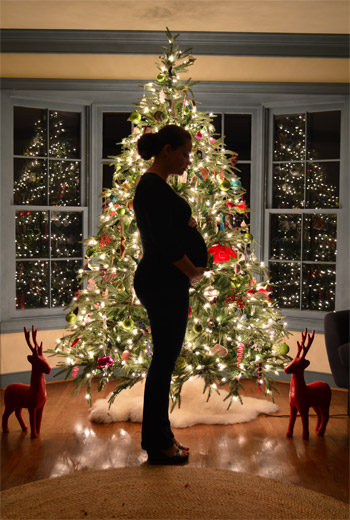 Maternity Portraits In Front Of The Christmas Tree