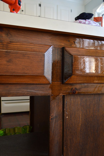 First coat of darker PolyShades stain on wood cabinet frames
