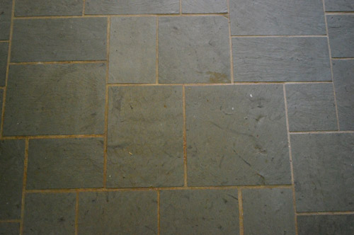 old discolored dirty grout lines on slate tile entryway floor