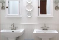 Luxe All White Bathroom Featuring Elegant Pedestal Sinks
