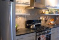 White Kitchen with Black Countertops and Open Shelving