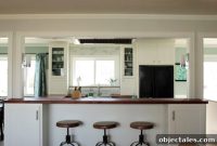 Kitchen with Glass Cabinets, Wood Counters and Marble Backsplash