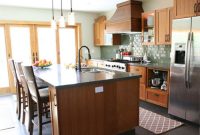 Sage Green Tile Kitchen with Warm Wood Cabinets