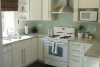 White Kitchen Featuring Green Glass Mosaic Backsplash