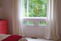Hang Curtains to Make Your Window Look Bigger