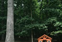 Add a Charming Little Wooden Playhouse to Your Backyard