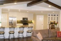 Living Room with Painted Paneling and Exposed Wood Beams