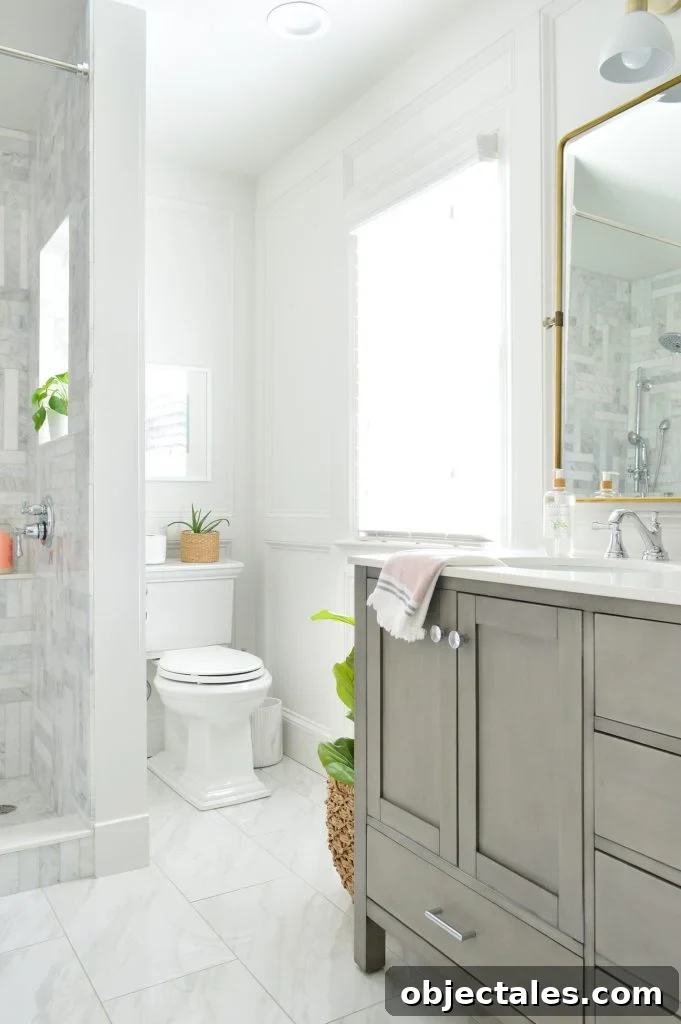 Which Toilet We Recommend: Our Favorite Model Revealed 7 View of toilet in back corner of marble bathroom with gray vanity