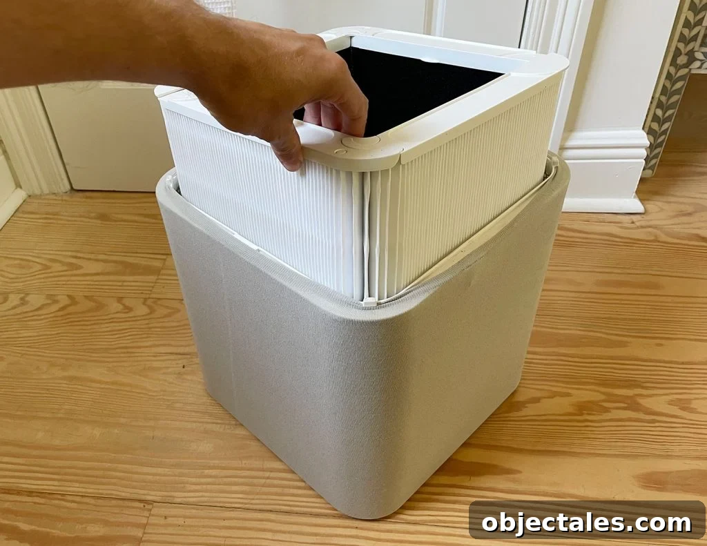 How to Choose a Home Air Purifier for Cleaner Indoor Air 10 Inserting New Clean Air Filter Into Blueair Blue 211 Air Purifier