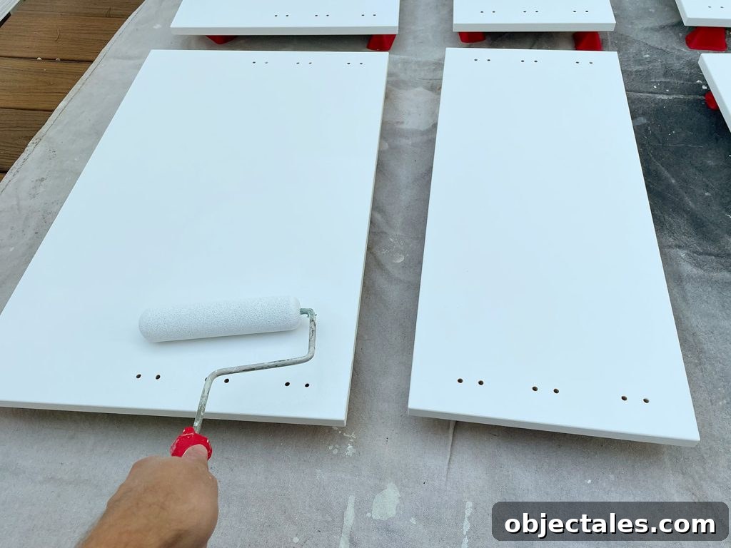 Applying Primer To Cabinet Door With Small Foam Roller