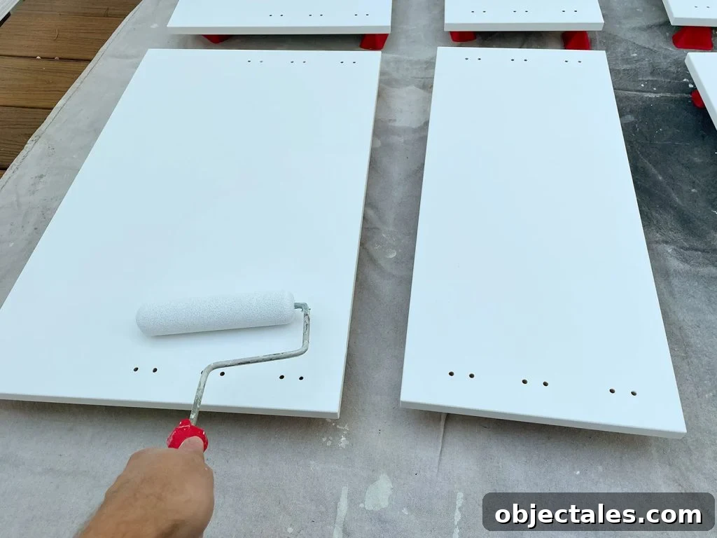 Applying Primer To Cabinet Door With Small Foam Roller