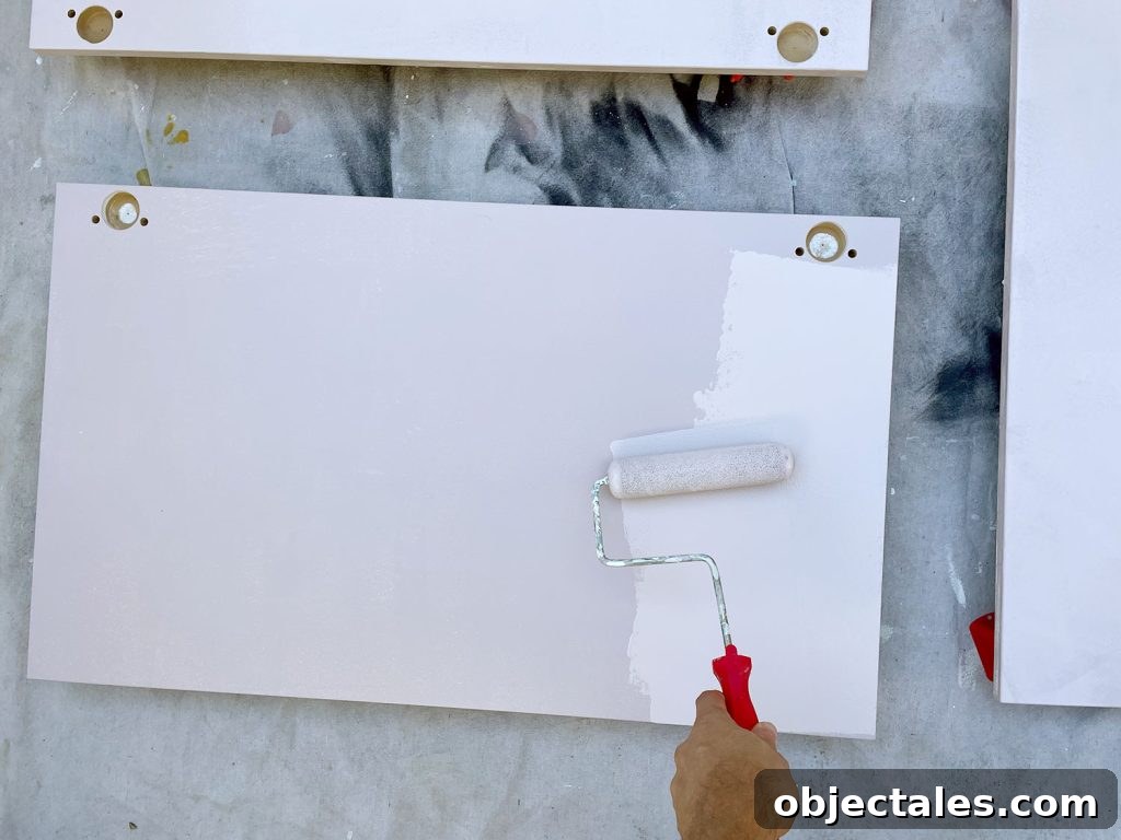 Applying Pink Paint To Ikea Kitchen Cabinet Doors With Small Foam Roller