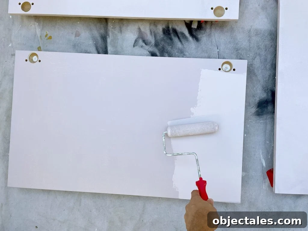 Applying Pink Paint To Ikea Kitchen Cabinet Doors With Small Foam Roller