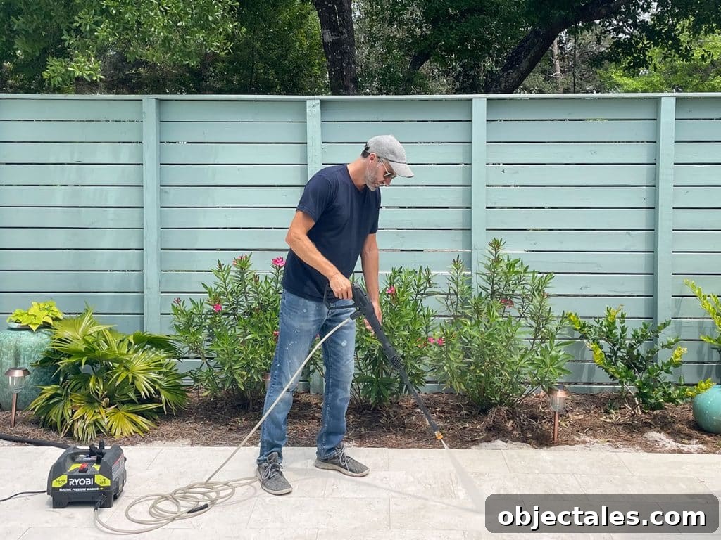 How to Use a Pressure Washer Safely: Step-by-Step Tips 2 John pressure washing pool deck patio with Ryobi electric power washer