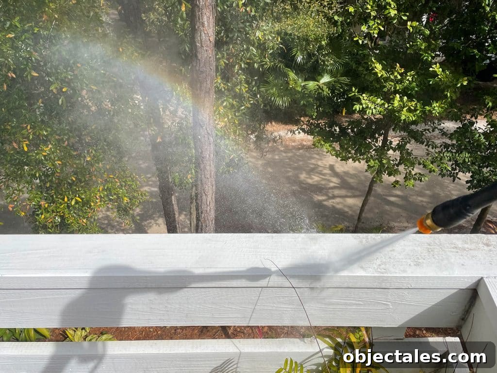 Rainbow created by overspray during pressure washing railings on deck