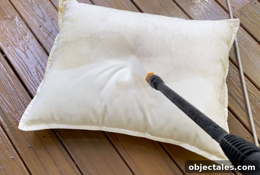 How to Use a Pressure Washer Safely: Step-by-Step Tips 14 Spraying Outdoor Pillow With Electric Pressure Washer