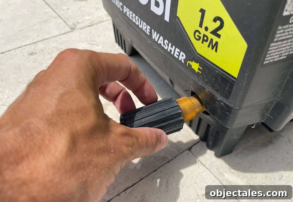 How to Use a Pressure Washer Safely: Step-by-Step Tips 5 Screwing high pressure hose to side of Ryobi Electric Pressure Washer