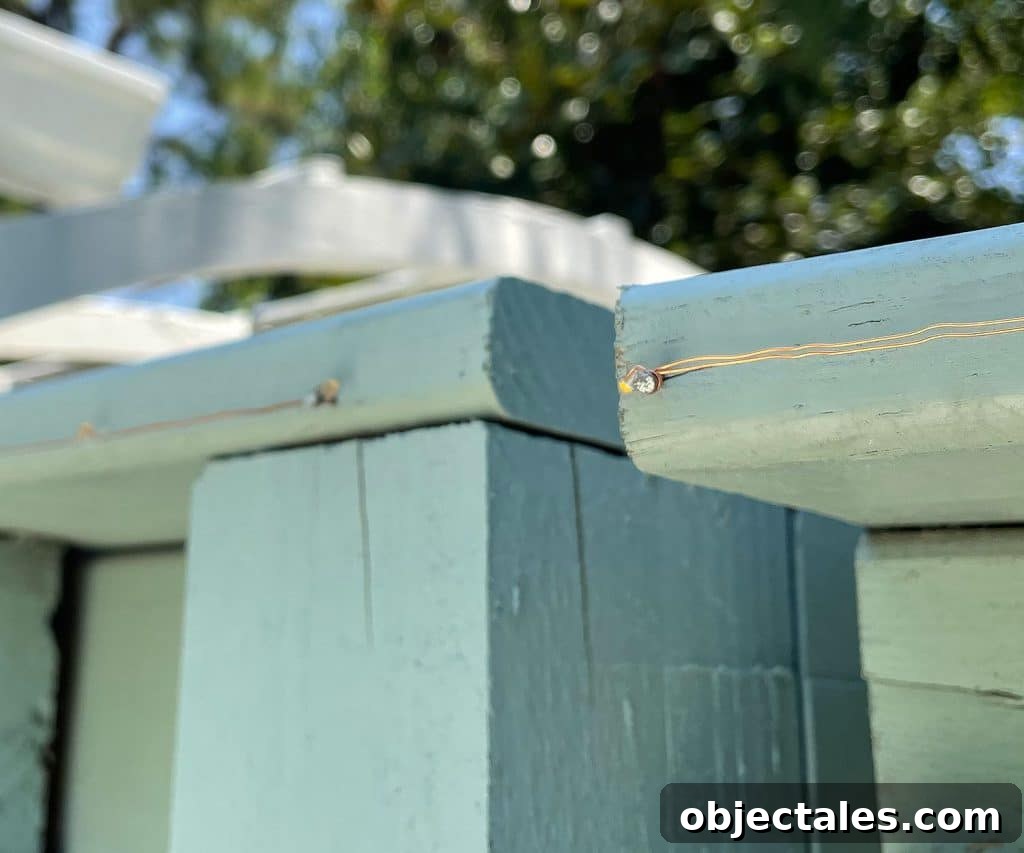 Top Outdoor Solar Lights for Brighter Yards and Patios 10 Detail Of Solar Fairy Light Wire Wrapped Around Nail In Fence
