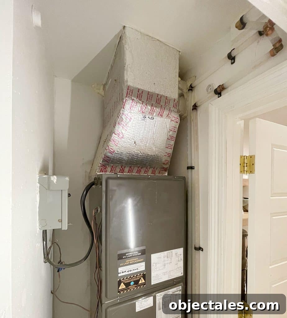 Utility Closet Storage Ideas to Maximize Space 11 View of inside of closet with clean plumbing pipes running behind door molding
