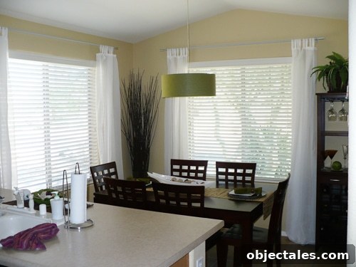 CB2 pendant light in green over dining area Green linen-style CB2 pendant light over dining table