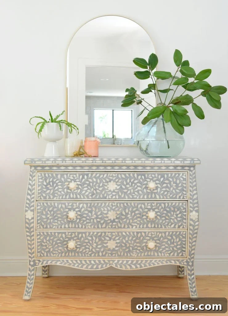 What We Kept After Downsizing Our Home 6 Blue and white inlay dresser with arch brass mirror and large plant vase