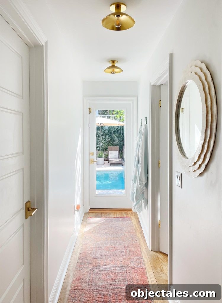 Rooms People Rarely Miss After Downsizing 5 Hallway With Traditional Rug Leading To Pool
