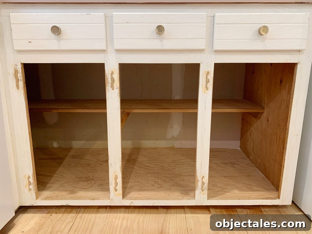Three lower cabinet frames sanded and holes filled with wood filler