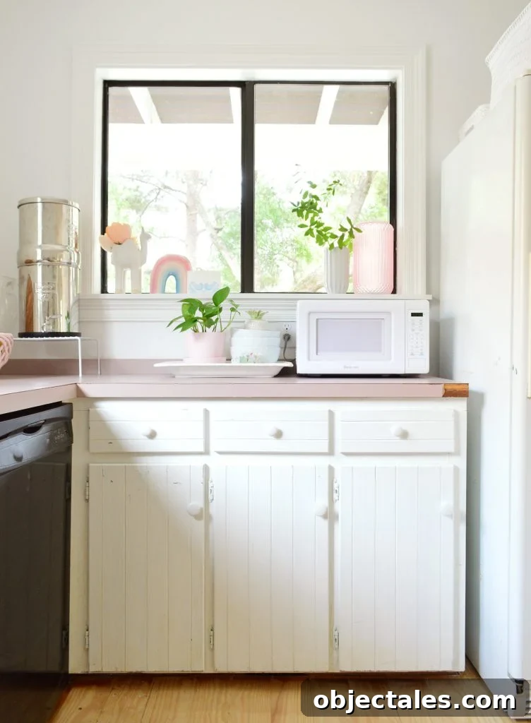 Before photo of kitchen with exposed white hinges on cabinet frames