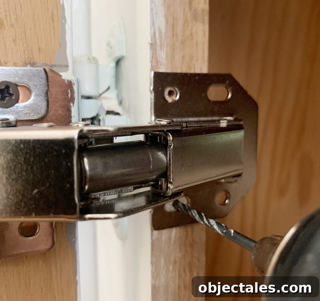 Drilling pilot hole through hidden cabinet hinge into cabinet frame