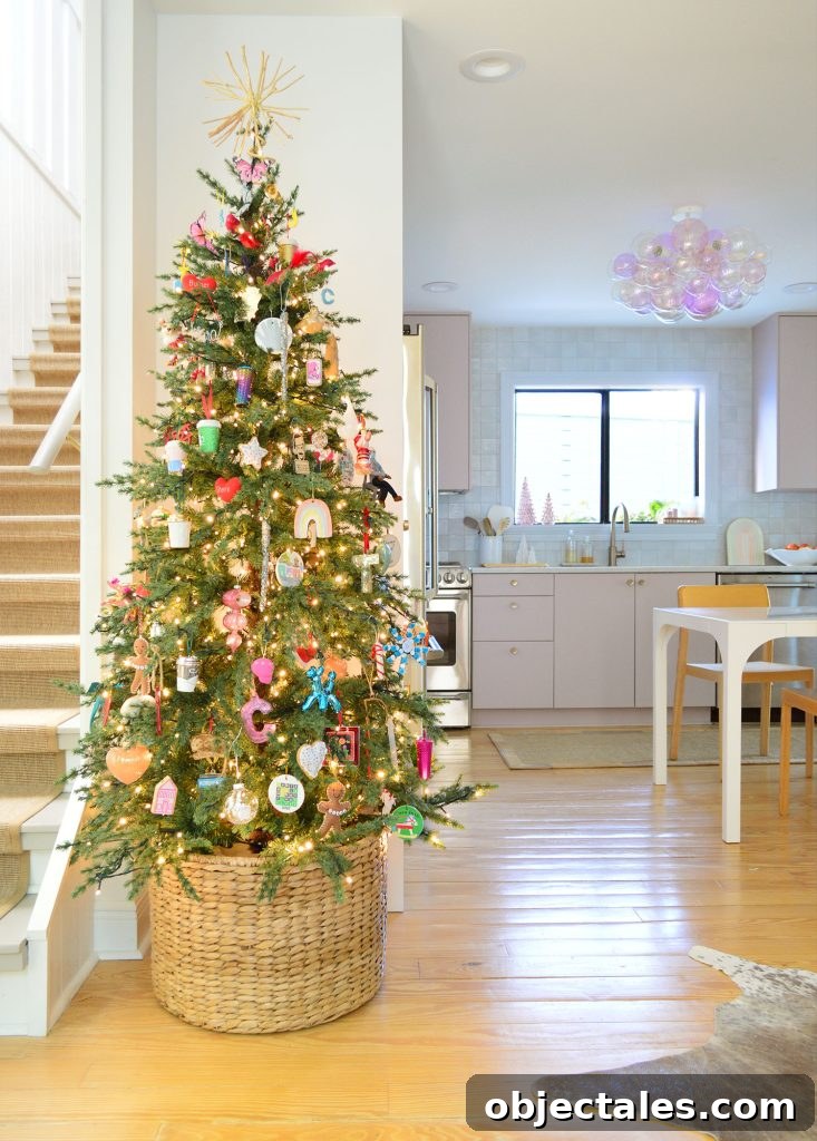 Slim Artificial Christmas Tree In Kitchen With Pink Cabinets