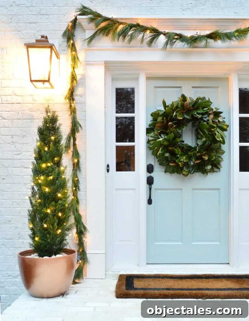 Holiday Front Porch With Magnolia Wreath and Faux Trees In Copper Pots