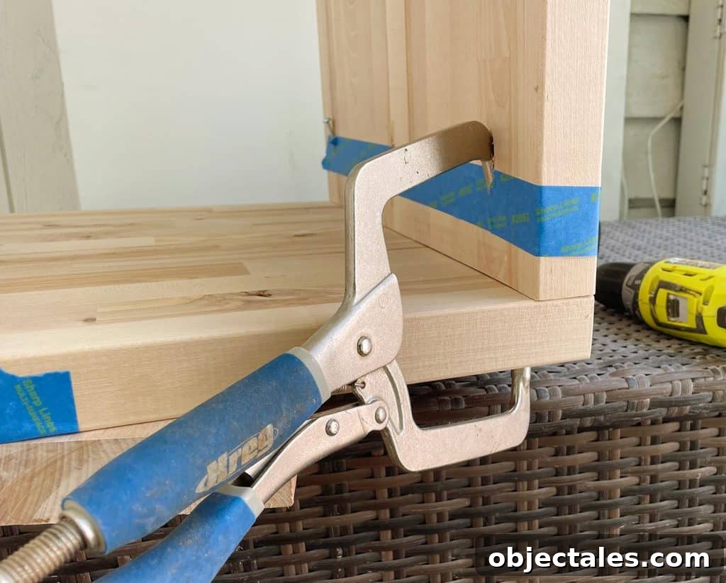Kreg Pocket Hole Clamp Holding Butcher Block Nightstands Together During Construction