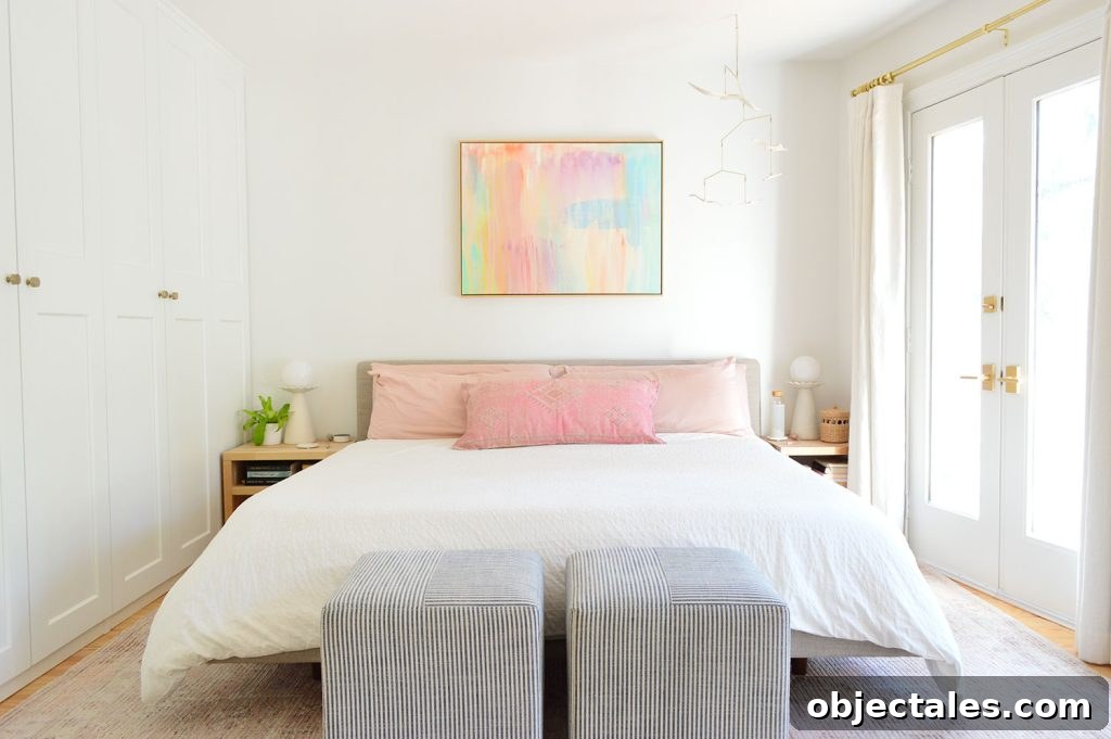 King Size Bed With White Bedding In Modern Bedroom With Striped Ottomans