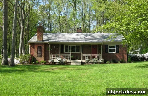 painted-propane-tank-front-of-house-camouflage-hide After photo of brick ranch with disguised utility boxes and propane tank and blooming flowers