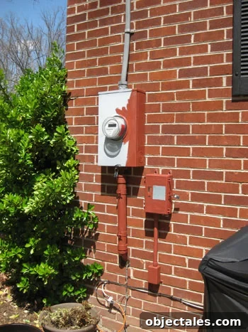img_8698 Half painted gray electrical utility meter box on back of brick ranch home